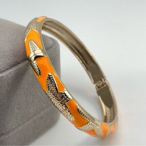 Orange Enamel Gold Tone Hinged Bangle Bracelet with Textured Starfish Design